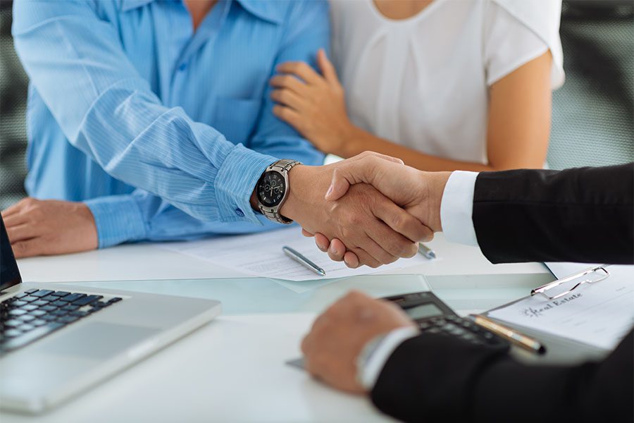 About Our Agency - Insurance Agent Shaking Hands with Couple in the Office