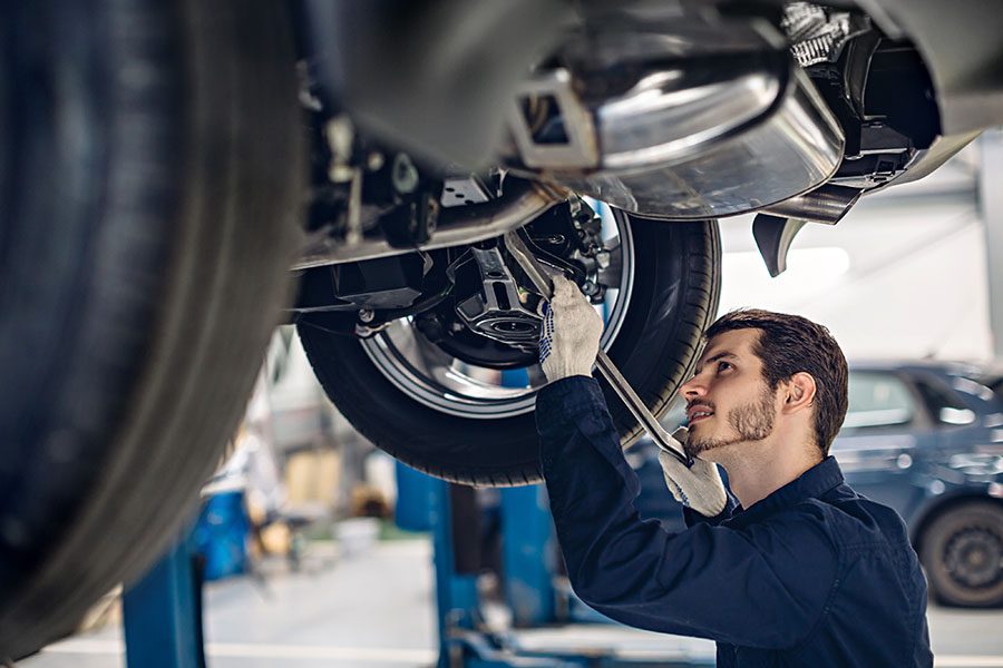 Specialized Business Insurance - Auto Mechanic Working on Car in Auto Garage Shop